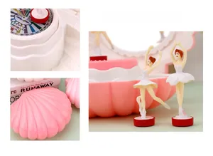 Pink shell musical jewelry box featuring ballerina figurines and internal mirror view