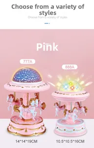 Comparison of two pink carousel music boxes with star projectors in different sizes