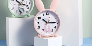 Detail view of the pink rabbit silent desk clock featuring large easy-to-read numbers