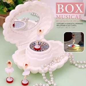 Pink shell-shaped music box with a rotating ballerina dancer and built-in vanity mirror