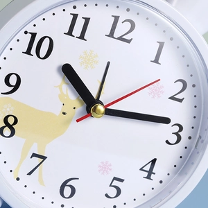 Minimalist round desktop alarm clock with cute cartoon deer and snowflake illustration