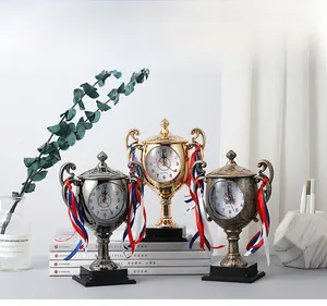 Detailed view of trophy clocks in gold silver and bronze with elegant handles