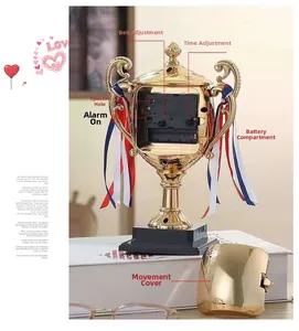 Detailed rear view of the gold trophy clock showing movement, battery slot and setting knobs