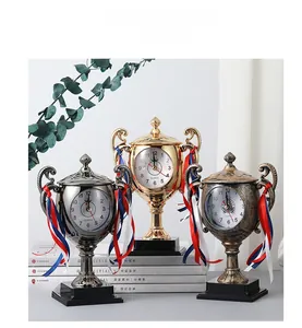 Trophy shaped quartz desk clocks in gold, silver and bronze finishes with decorative ribbons