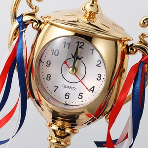 Creative gold trophy desk clock with quartz movement and decorative ribbons