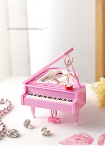 Detailed view of pink piano music box featuring a spinning ballet dancer on top