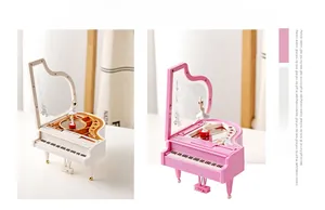 Detail of mechanical piano music box with rotating ballerina in white and pink finish