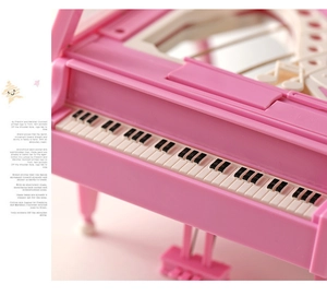 Detailed macro view of pink music box piano keys and embossed musical notes inside