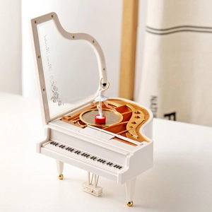 White grand piano music box with a rotating ballerina and elegant golden accents
