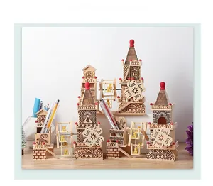 Close-up of wooden music box with windmill, castle towers and Good Luck engraving