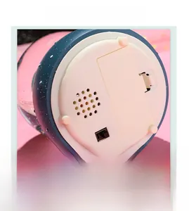 Detail view of the astronaut music box base featuring the power switch and battery compartment