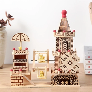 3D wooden windmill music box puzzle with red turret and miniature ferris wheel on table