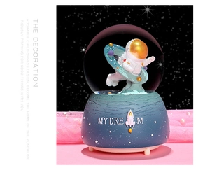 Detailed close-up of astronaut crystal ball with floating spaceman and blue Dream base
