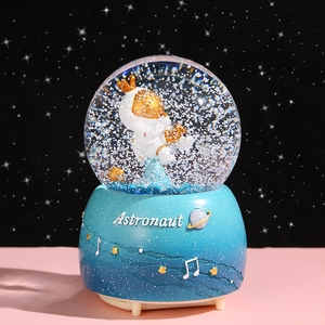 Astronaut snow globe music box with crown figure and gradient blue base for gift
