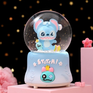 Detail of Stitch music box with floating snow and embossed blue tropical base