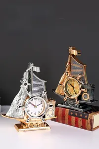 Macro view of vintage sailing boat alarm clocks in gold and bronze metallic finishes