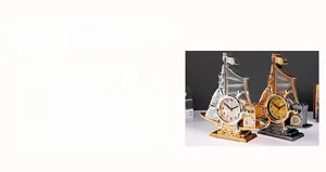 Detail of vintage sailboat desk clocks in bronze and gold finish with Roman numerals