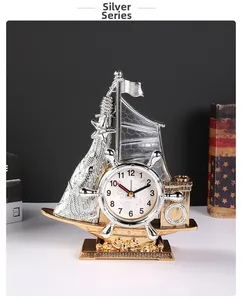 Detail of vintage sailboat clock with integrated pen holder and metallic silver finish