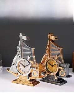 Macro shot of vintage sailing boat alarm clocks in gold and silver metallic finishes