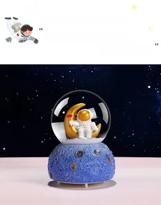Astronaut music box crystal ball with astronaut on golden moon and starry night base