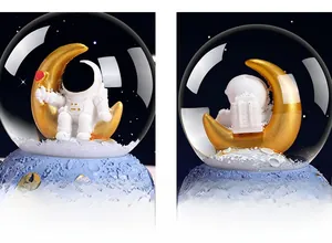Close-up of astronaut snow globe with moon seat and starlit crater textured base
