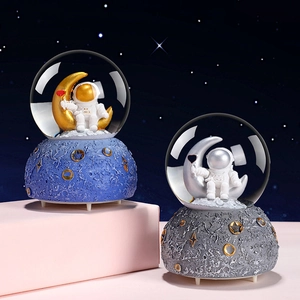 Astronaut snow globe music box with cosmic moon base and starry night background