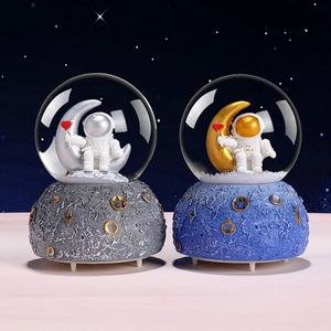 Astronaut crystal ball ornaments with glowing moon and colorful stars for home decor