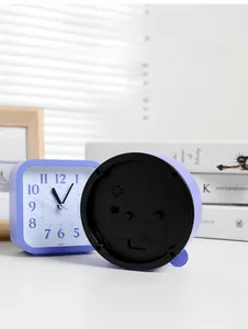 Detail view of purple alarm clock showing silent movement back panel and front dial face