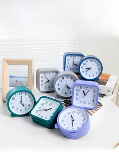 Detailed scene of silent analog alarm clocks in various Morandi colors on a desk