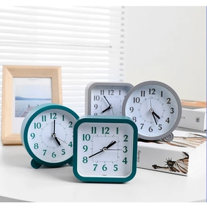 Minimalist desktop alarm clocks in square and round shapes with a Nordic style scene