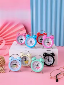 Close-up of colorful mini alarm clocks with cartoon animal and fruit designs for kids