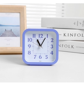 Close-up of minimalist purple square desk clock with white dial and Arabic numerals
