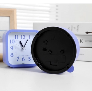 Detail view of purple alarm clock showing numeric dial and rear functional knobs