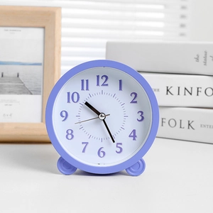 Minimalist purple round desktop alarm clock with analog display and modern Nordic style