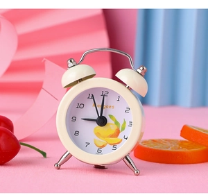 Mini cream-colored alarm clock featuring a mango dial pattern on colorful artistic paper