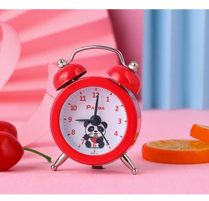 Detailed close-up of a mini red twin bell alarm clock with a cute panda cartoon illustration