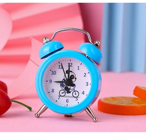 Detailed view of mini blue cartoon panda alarm clock on a colorful decorative backdrop