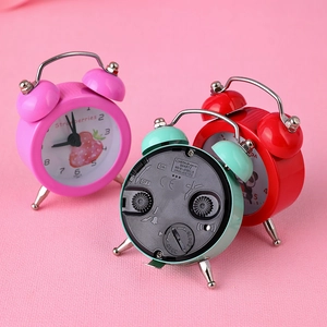 Mini portable cartoon alarm clocks in pink, red, and blue with quartz movement