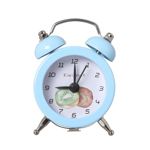 Mini light blue alarm clock with kiwi design and metal double bells on white background