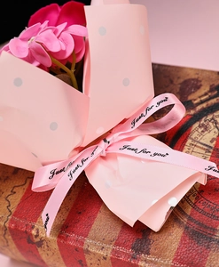 Detail of pink artificial bouquet with polka dot paper and Just For You ribbon decoration