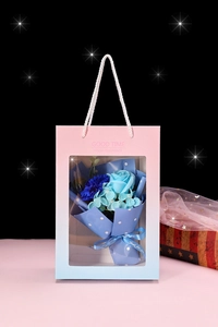 Close-up of blue soap flower bouquet in a gradient window gift bag with Just for you ribbon