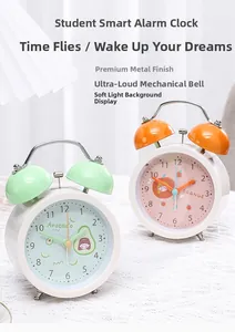 Detail of twin bell alarm clocks in mint green and orange with cute fruit illustrations