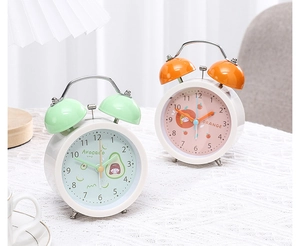 Close-up of mint avocado and orange fruit series dual-bell bedside alarm clocks