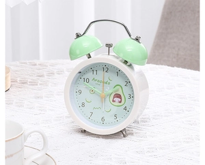 Close-up of a white twin bell alarm clock with avocado dial design and green bells