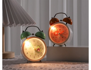 Detail of candy color fruit alarm clocks featuring night light and double bell design