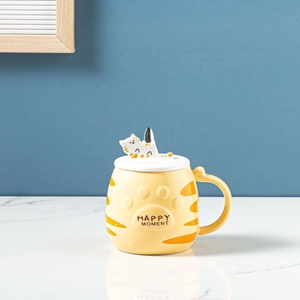 Close-up of cat ceramic mug with orange stripes, 3D kitten topper, and happy moment text