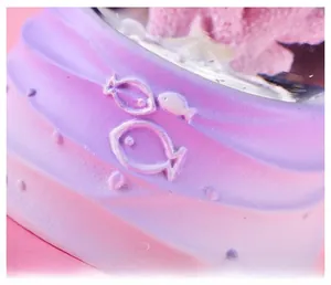 Macro detail of lavender gradient base with embossed fish patterns on crystal ball ornament