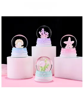 Detailed view of ocean theme crystal balls with gradient coral and shell bases