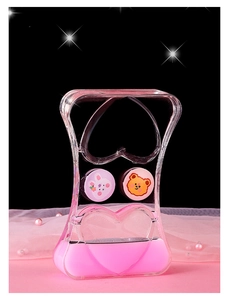 Macro detail of heart liquid timer with pink oil drops and cute cartoon characters