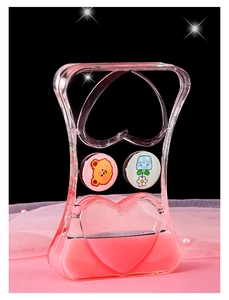 Macro detail of acrylic liquid hourglass featuring pink floating hearts and cute bear motifs